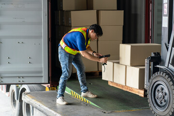 Workers lifting boxes from a forklift, moving stuff to a truck and checking the coach, checking the product code before shipping the logistics to the customer.