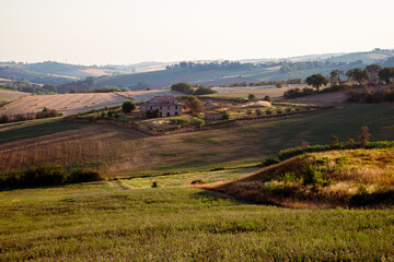 Naklejka premium Farmhouse in the fields in the hills between Pesaro and Tavullia in Italy