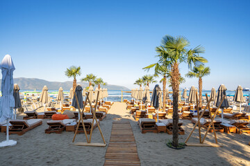 Beach umbrellas from the sun and sun loungers on the beach.