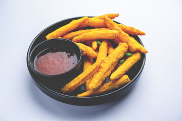 Crispy fried baby corn pakoda, pakora  or Baby corn fritters served with ketchup, Indian food