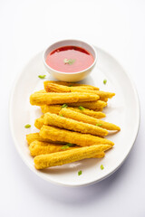 Crispy fried baby corn pakoda, pakora  or Baby corn fritters served with ketchup, Indian food