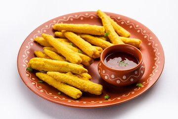 Crispy fried baby corn pakoda, pakora  or Baby corn fritters served with ketchup, Indian food