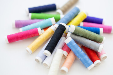 Fototapeta na wymiar Sewing threads on white