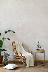 Bamboo armchair standing against grey wall in living room