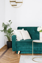 Living room interior with green velvet sofa