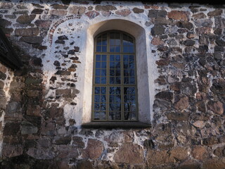 Fototapeta na wymiar The wall and the window of Sibbo Old Church, Sippo Finland