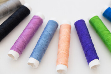 top view of bright and colorful threads on white background