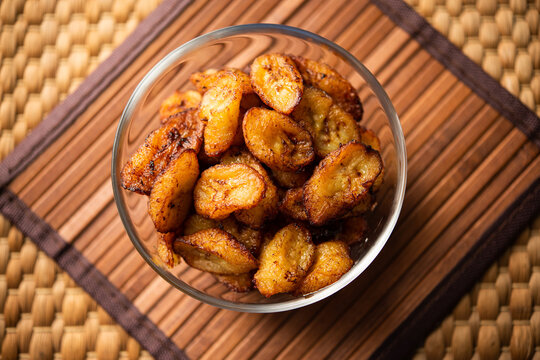 Deep fried ripe plantain slices or pake kele fried chips in a bowl