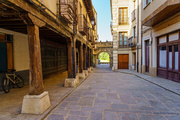 Arcades of medieval buildings in the alley of access to the main square of the town, San Esteban de Gormaz.