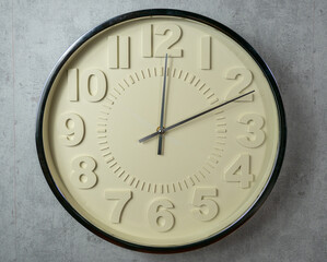 Wall clock on a gray background. Clock close up.