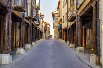 Main street with medieval arcades made of wooden columns in San Estaban de Gormaz, Soria.