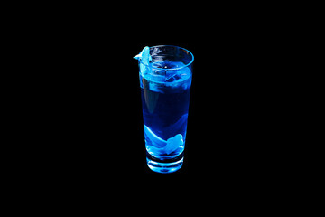 ..Cocktail glass with blue alcoholic drink  decorated with jelly acula. Isolated on black. .