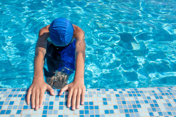 Swimmer in the pool. Swimming pool. The swimmer is ready to swim. Top view of a guy in a swimming...