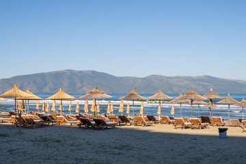 Beach umbrellas from the sun and sun loungers on the beach.