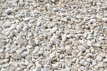 Expanse of white different sizes gravel in a construction site used in the construction industry and building activity for the construction of roadbeds