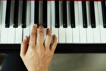 A man plays and practices piano in a music room at school. favorite classical music Show your...