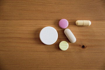 Fototapeta na wymiar Various pills on a wooden table