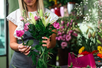 Gardener's in the flower shop make bouquet for a holiday. Family flower's business. Lifestyle flower shop. Beautiful flower composition. Detail. Close up..