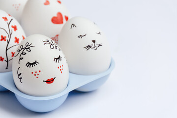 Close up of beautifully painted Easter eggs - gentle beauty with red lips, cat's face, hearts and...
