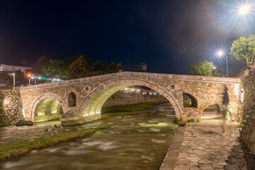 Fototapeta na wymiar Historic Stone Bridge over Bistrica river at night in Prizren, Kosovo.