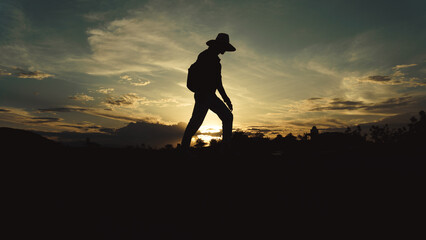 man traveler walking at sunset through the desert, silhouette of a man