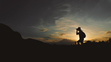 man traveler walking at sunset through the desert, silhouette of a man