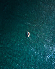 Aguadilla surfer beach deep blues aerial top down captures background from Puerto Rico.	