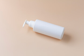 White plasstic bottle isolated on pastel color background, fluid pump container for cosmatic product, flat lay, top view.