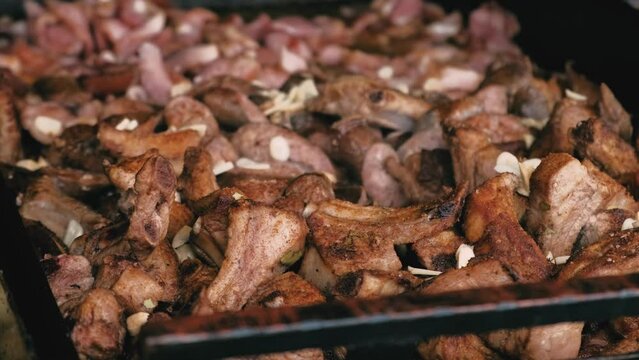 Close up footage of Romanian street food, frying tasty meat in big pan.
