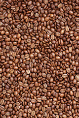 Roasted coffee beans texture for background. Organic natural roast grain background with copy space for text, top view. Close up grains flat lay. Healthy food macro concept.