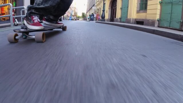 Close-up view of a skateboard moving along a Budapest street.