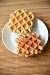 Golden delicious viennese waffles wooden. Wooden background. Raspberry isolated. Gourmet food.