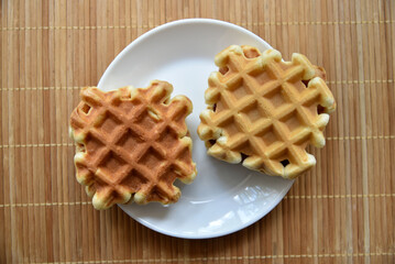 Golden delicious viennese waffles wooden. Wooden background. Raspberry isolated. Gourmet food.
