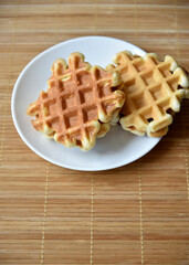 Golden delicious viennese waffles wooden. Wooden background. Raspberry isolated. Gourmet food.