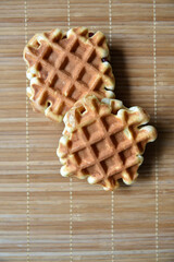 Golden delicious viennese waffles wooden. Wooden background. Raspberry isolated. Gourmet food.