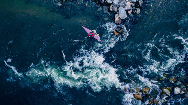 Top view kayaker on mountain rough river, extreme kayak boat, aerial drone photo