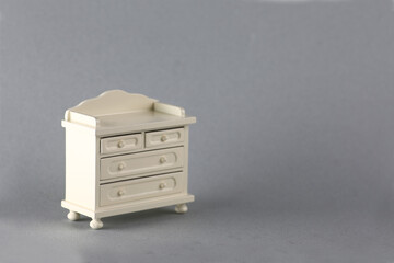 dollhouse interior - old-fashiobed white commode isolated on gray background