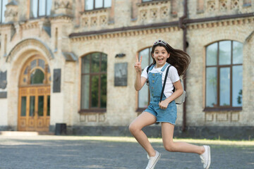 Fototapeta na wymiar amazed teen kid jump. energetic teen girl jump outdoor. free teen child jump