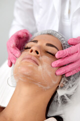 Obraz na płótnie Canvas Woman having cleaning facial treatment in spa