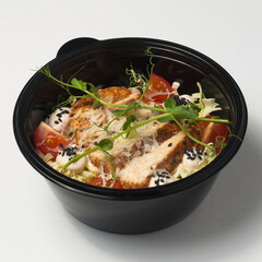 caesar salad in a plastic container. concept: food delivery, fast food