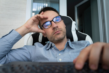 uninteresting boring work in the office concept. Sleepy bored man employee sitting at desk has no...