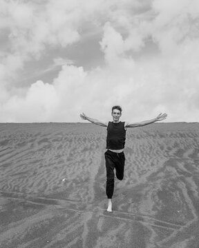 Lone man running on the sand through sandy desert