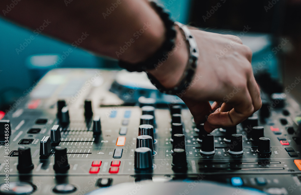 Wall mural DJ Hands creating and regulating music on dj console mixer in concert outdoor