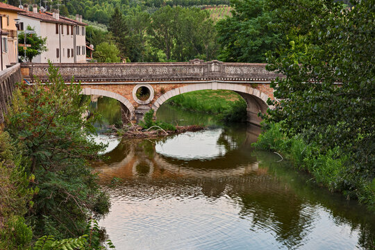 Fiumana, Predappio, Emilia Romagna, Italy - landscape of the village with the river Rabbi and the ancient bridge built in the 20-30s in rationalist architecture