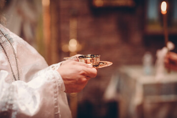 person holding a glass of wine in a restaurant