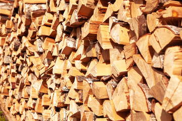 Textured firewood background of chopped wood for kindling and heating the house.