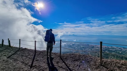 Papier Peint photo autocollant Naples Man with backpack enjoying scenic view from volcano Mount Vesuvius on bay of Naples, Province of Naples, Campania, Italy, Europe, EU. Looking at city of Naples and Mediterranean coastline on sunny day