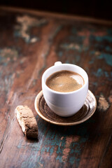 Cup of coffee and Cantuccini (Italian cookie) on dark wooden background. Close up. Copy space.