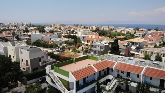 Beach Hotels And Apartments In Ialysos Town On Rhodes, Greece. - aerial pullback