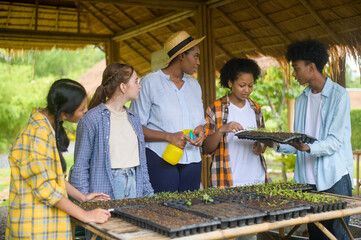 Group of mixed race students and teacher learning agriculture  technology in smart farming ,...